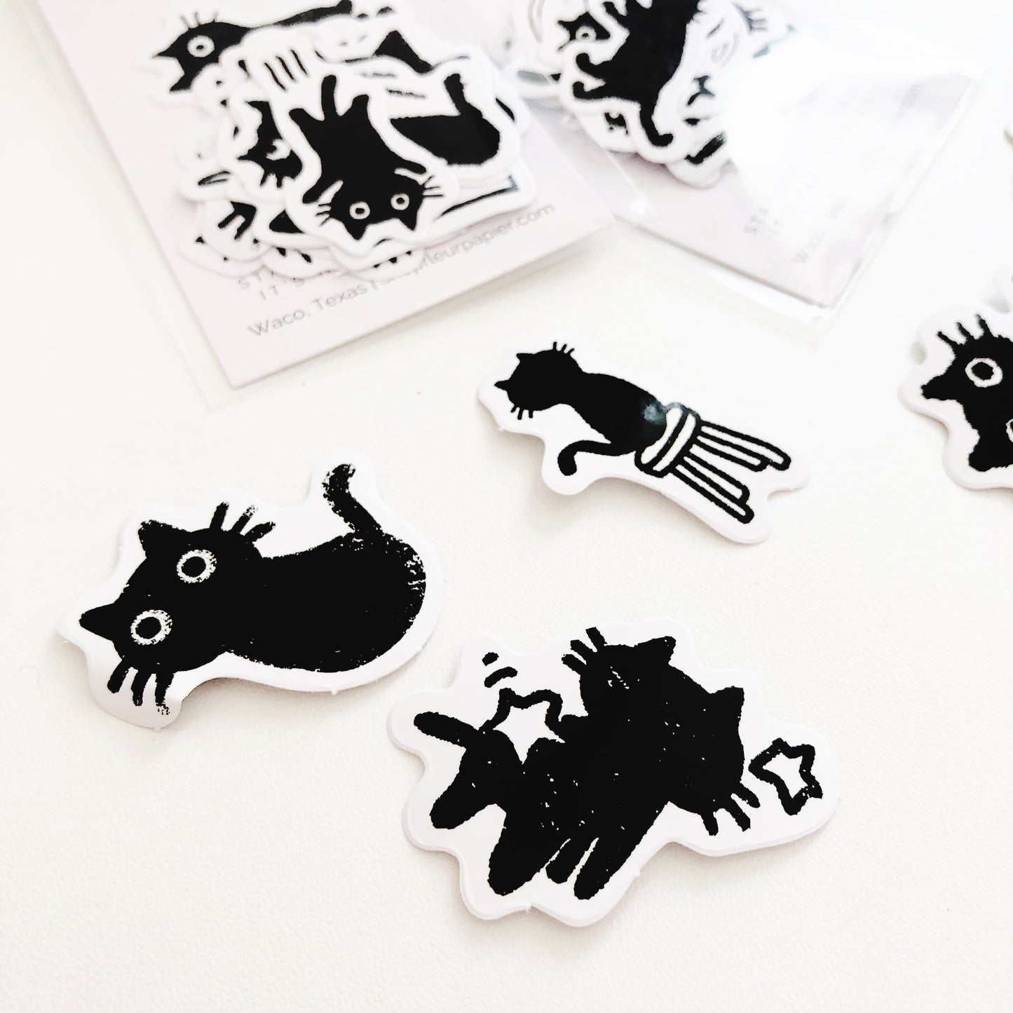 A variety of black cat stickers with different poses and expressions.