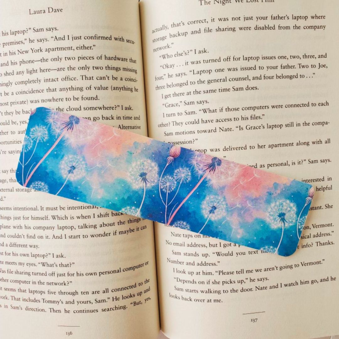 Blue and pink dandelion bookmark on an open book