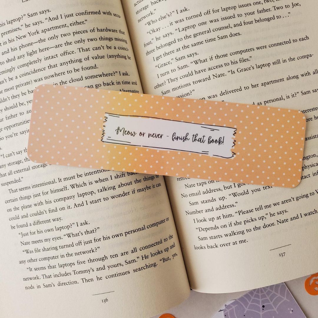 Yellow polka-dot Halloween bookmark with label that reads 'Meow or never – finish that book!