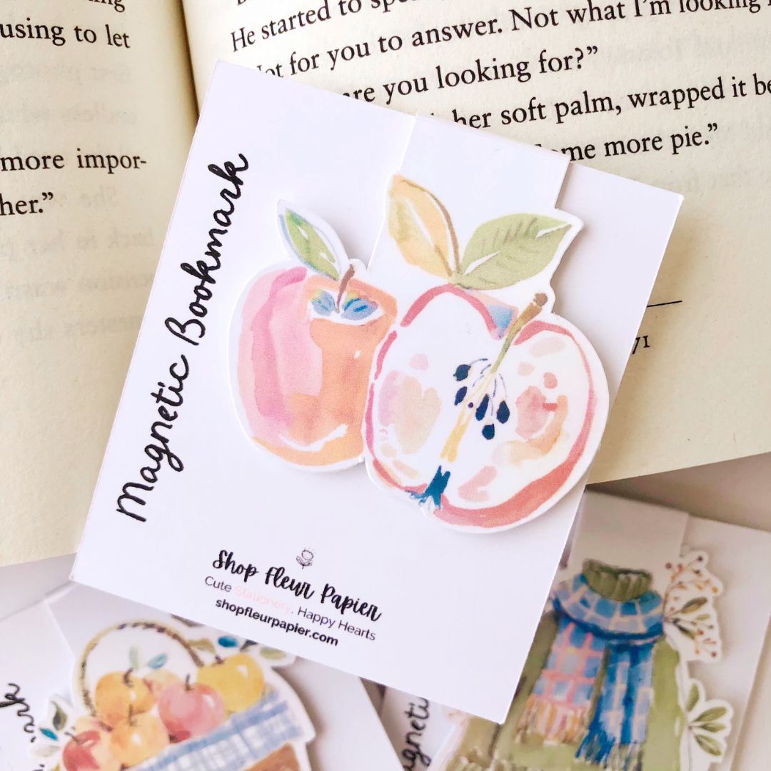 Magnetic bookmark with apple design on a book page