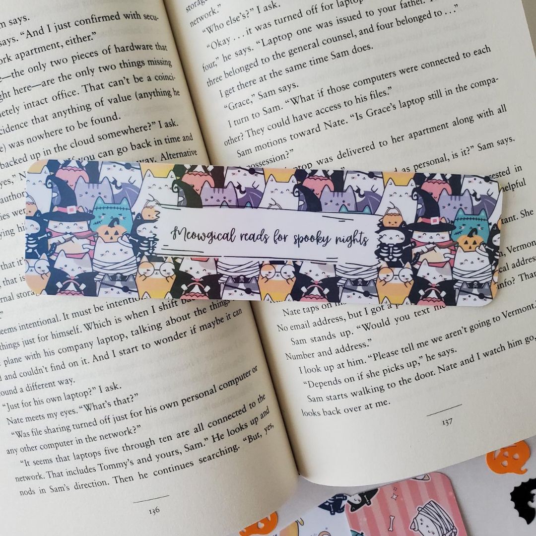 Halloween bookmark showing cats dressed in a mix of spooky costumes including mummies, bats, and pumpkins.
