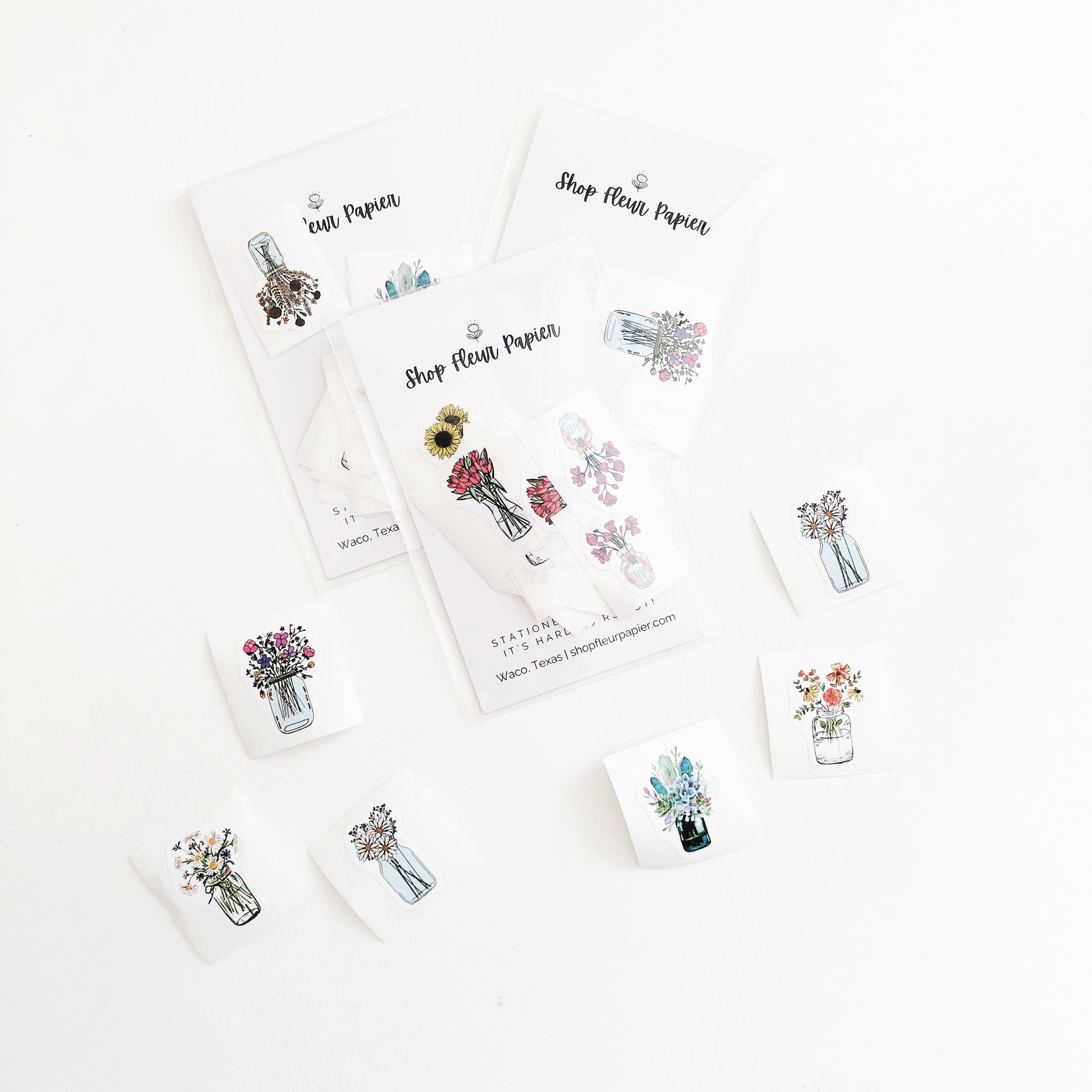 A variety of tiny flower stickers in mason jars.