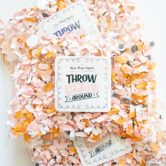 Packaged decorative paper shreds with a 'Throw Yourself Around' label on a white background